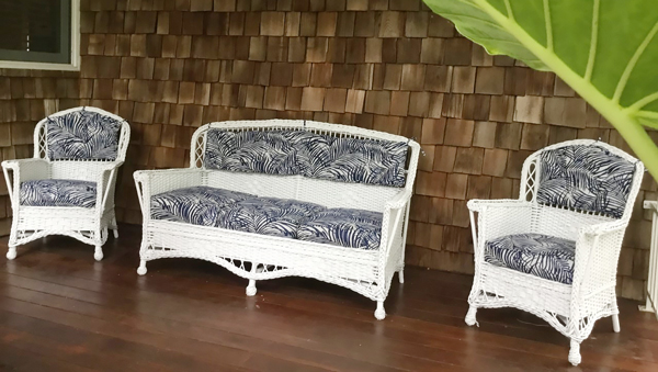 Wicker furniture with navy palm fronds cushions