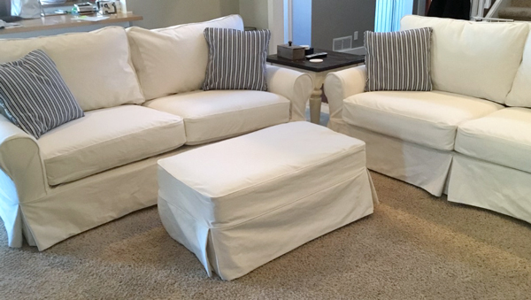 Cream slipcover for couch and ottoman